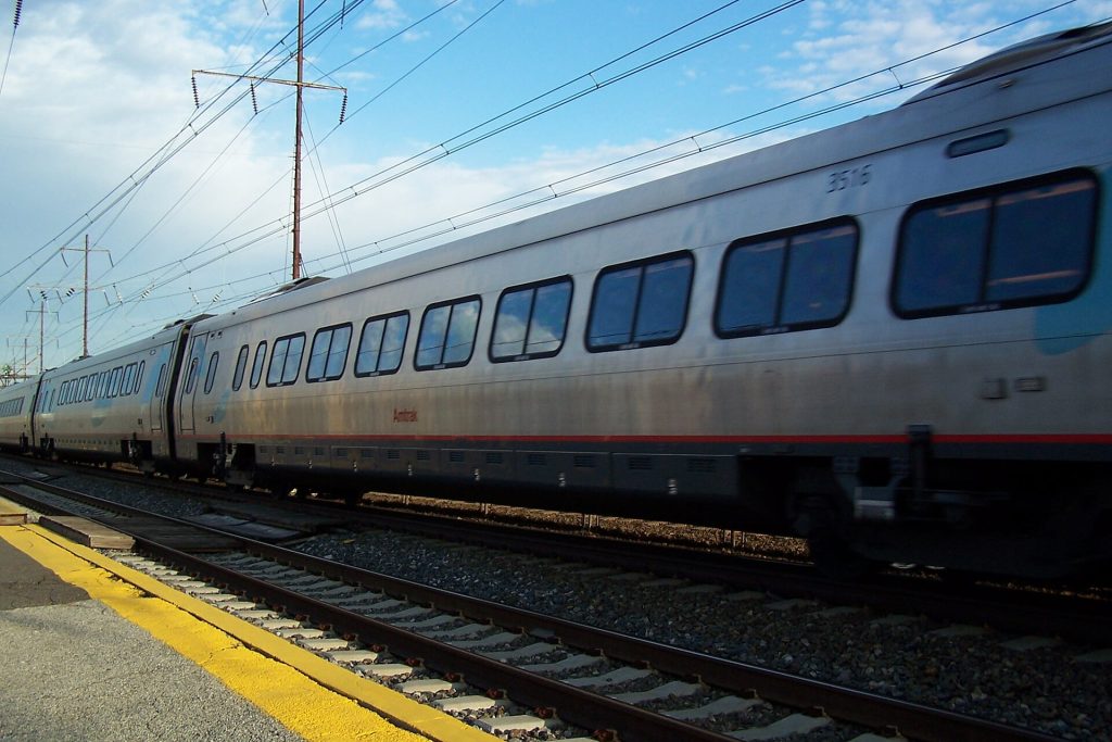An Amtrak Acela speeds by the Prospect Park-Moore commuter station south of Philadelphia on the Northeast Corridor. Note the super-elevation of the tracks.