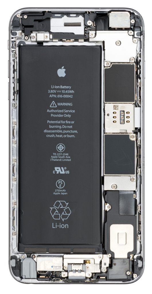 The inside of an iPhone 6S Plus, a cellular phone made by Apple that was introduced in 2015. A phone found on the street, the front/glass element had been completely destroyed and was removed to show the phones interior. Shielding elements over the phone's motherboard have been left on.