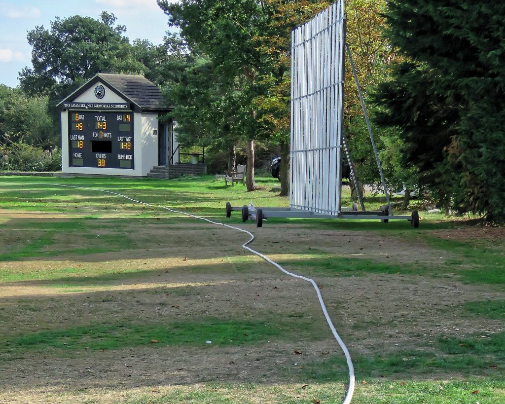 The cricket ground scoreboard, sight screen and boundary rope of Botany Bay Cricket Club at Botany Bay village in Enfield, London, England.Mobile device view: Wikimedia (as at 2018) makes it difficult to immediately view photo groups related to this image. To see its most relevant allied photos, click on Botany Bay Cricket Club, and this uploader's Cricket photos. You can add a beta click-through 'categories' button to the very bottom of photo-pages you view by going to settings... three-bar icon top left.Desktop view: Wikimedia (as at 2018) makes it difficult to immediately view the helpful category links where you can find images related to this one in a variety of ways; for these go to the very bottom of the page.This image is one of a series of date and/or subject allied consecutive photographs kept in progression or location by file name number and/or time marking.Camera: Canon PowerShot SX60 HSSoftware: File lens-corrected, optimized, perhaps cropped, with DxO PhotoLab, and likely further optimized with Adobe Photoshop CS2.