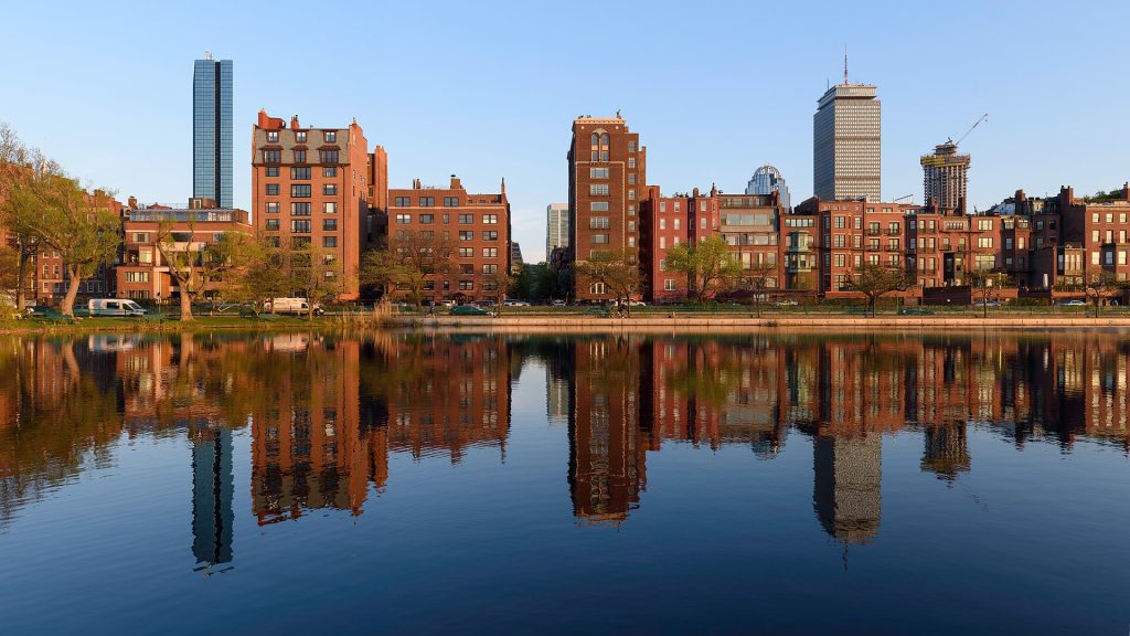 Three-segment panorama of Back Bay buildings reflected in Storrow Lagoon, Charles River Esplanade, Boston.