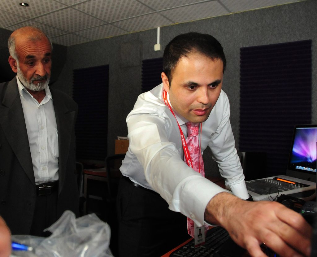 Kabul Afghanistan, Tri-Vision representative Sularman Lutfi shows Col Abdel Latif of the Ministry of Interior (MOI) Public Affairs how to start up the equipment in MOI’s new control room. The two day training began today and covers a state-of-the-art facility includes: a control room with production suites, a sound-proof audio booth, a radio round table with the ability to interview 5 persons simultaneously and a television section.