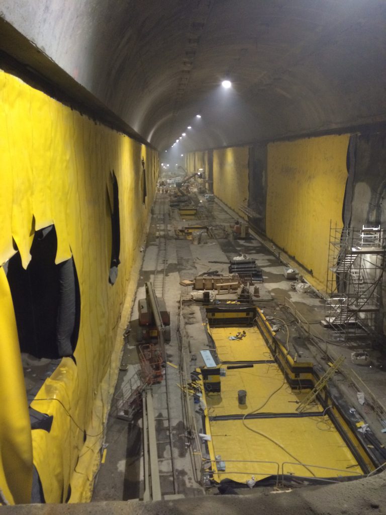 This cavern, some 150 feet below Grand Central, will house part of the new LIRR East Side Access station platforms, accommodating total of four trains - two each on an upper & lower level. The cavern is 1,150 feet long by 65 feet high by 60 feet wide. Two such caverns will hold a total of 8 trains. The yellow material seen in the photo is part of the waterproofing process. Photo: MTA Long Island Rail Road / Joe Calderone