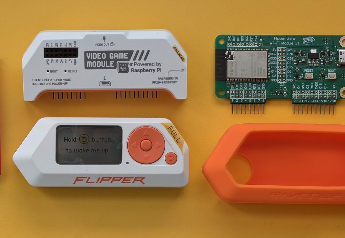 A flat lay technical layout on a yellow background demonstrating the physical scale and size of the Flipper Zero hardware ecosystem. It displays the main white/orange Flipper Zero unit in standby mode, the official Video Game Module (powered by Raspberry Pi), the Wi-Fi Developer Board v1.1 module (powered by an ESP32-S2 microchip), and an orange silicone protective bumper casing. A standard red BIC pocket lighter is placed on the left side of the frame serving as an everyday reference object to demonstrate scale