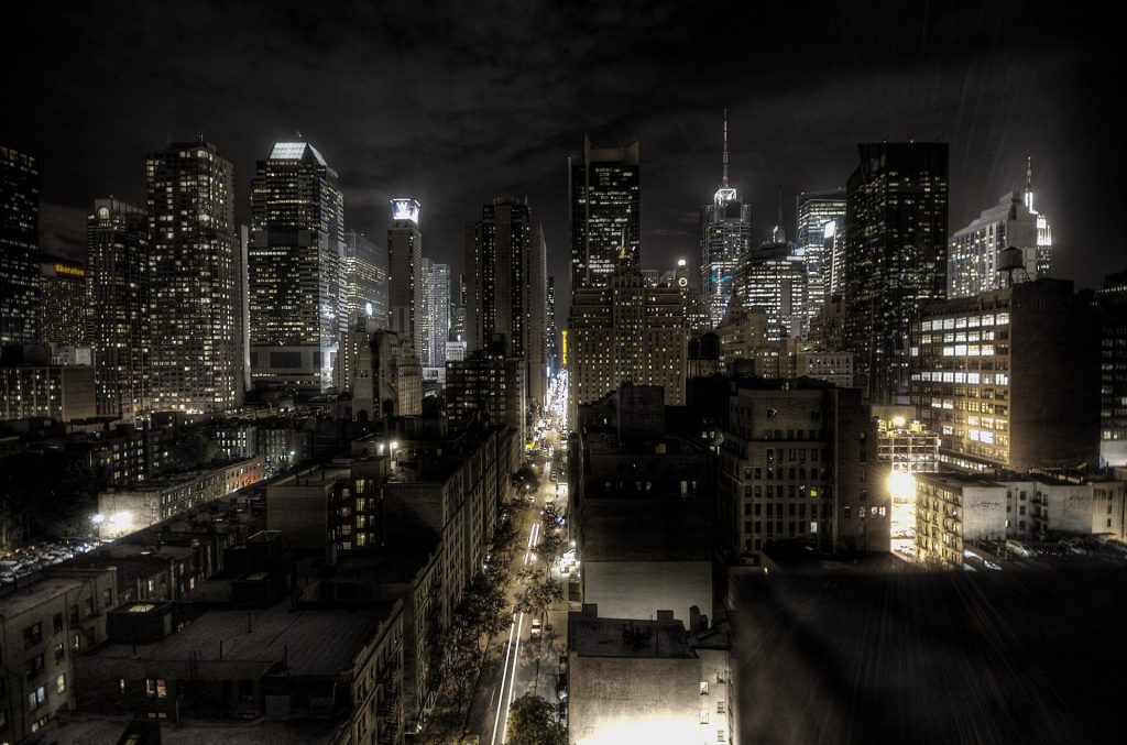 New York City at night, photographed using the HDR technique. Looking east along West 45th St. The yellow sign in the center is Milford Plaza Hotel.
