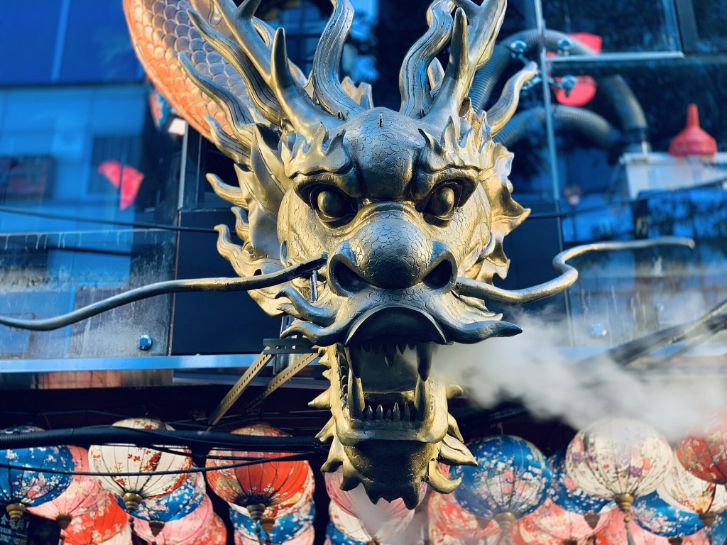 This is a image of a dragon sculpture that blows steam infrequently at Ximending.