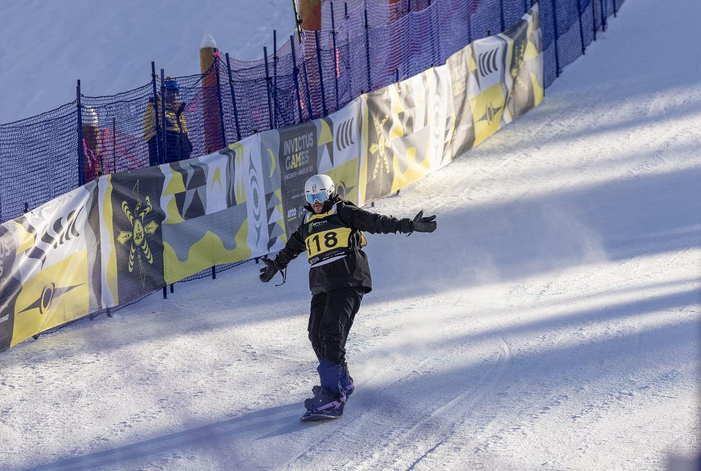 Aaron Gomez, a U.S. Coast Guard veteran and competitor for Team U.S., responds to the crowd after crossing the finish line for the snowboarding slalom in the 2025 Invictus Games in Whistler, Canada, Feb. 12, 2025.Fifty competitors make up Team U.S., which is competing along with 22 other nations in the 2025 Invictus Games. Throughout the competition, events will take place in Vancouver and Whistler, Canada, from Feb. 8-16, 2025. The competition includes 11 different events, including six adaptive winter sports, the first year that winter-specific sports have been part of the Invictus Games competition. The Invictus Games is an international sporting event for wounded, injured, and ill active duty and veteran military personnel. The Games use the power of sport to support recovery, rehabilitation and generate a wider understanding and respect for those who serve their country. The Invictus Games, like the DoD Warrior Games, are designed to enhance recovery by engaging wounded, ill, and injured service members outside of traditional therapy settings. (U.S. Army photo by Michel Sauret)