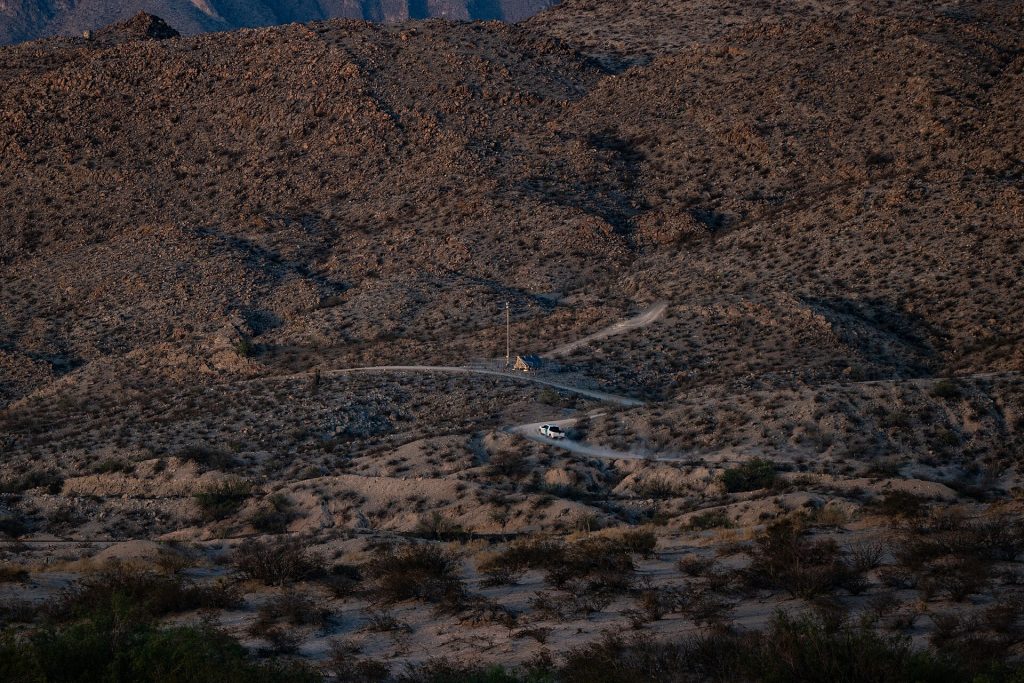 Autonomous Surveillance Tower (AST), manufactured by Anduril Industries and operated by U.S. Customs and Border Protection (CBP), and U.S. Border Patrol vehicle on Mount Cristo Rey in Sunland Park, New Mexico, in May 2024.