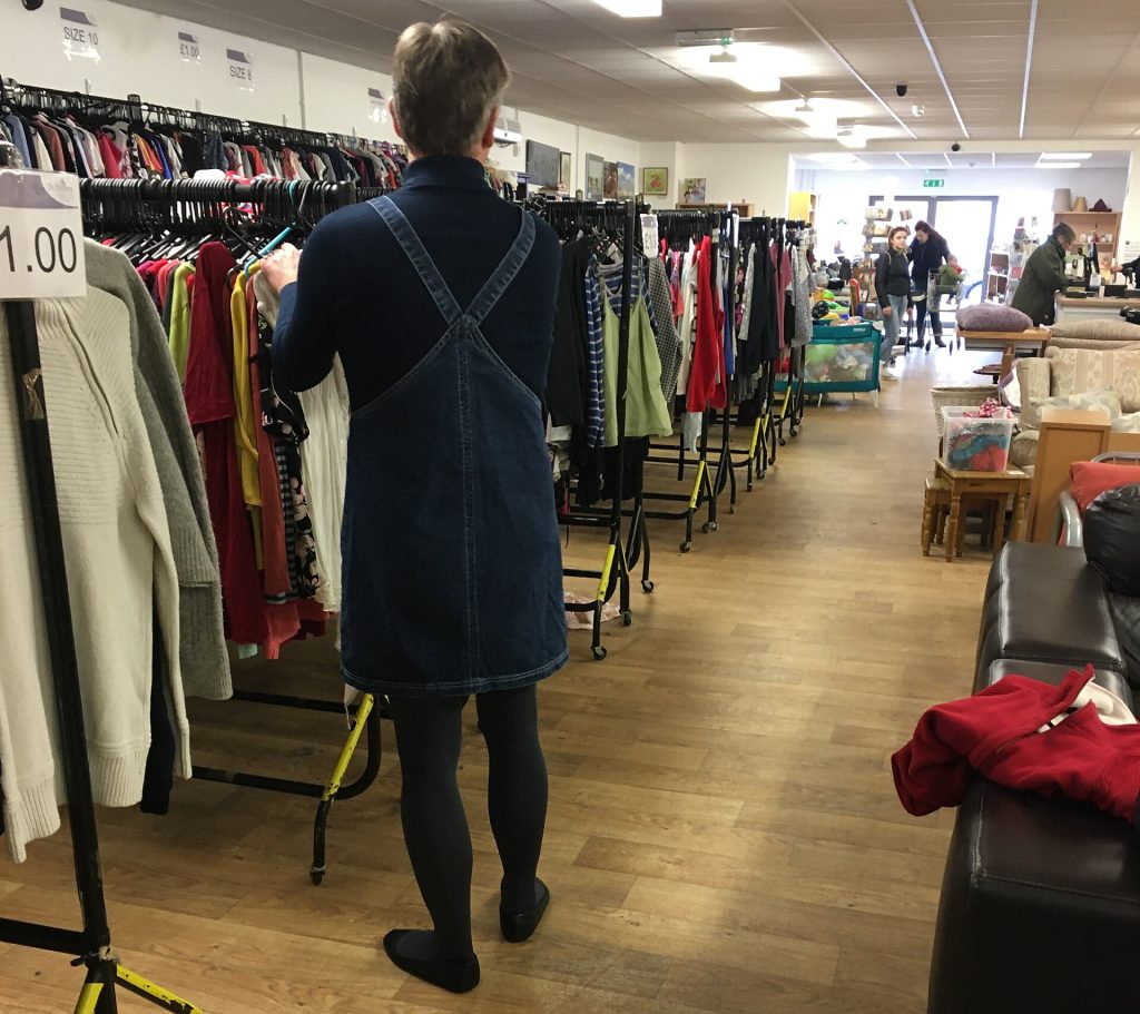 Denim bib dress, navy blue ribbed sweater, grey 100 denier opaque tights and ballet flats worn while working in charity shop.