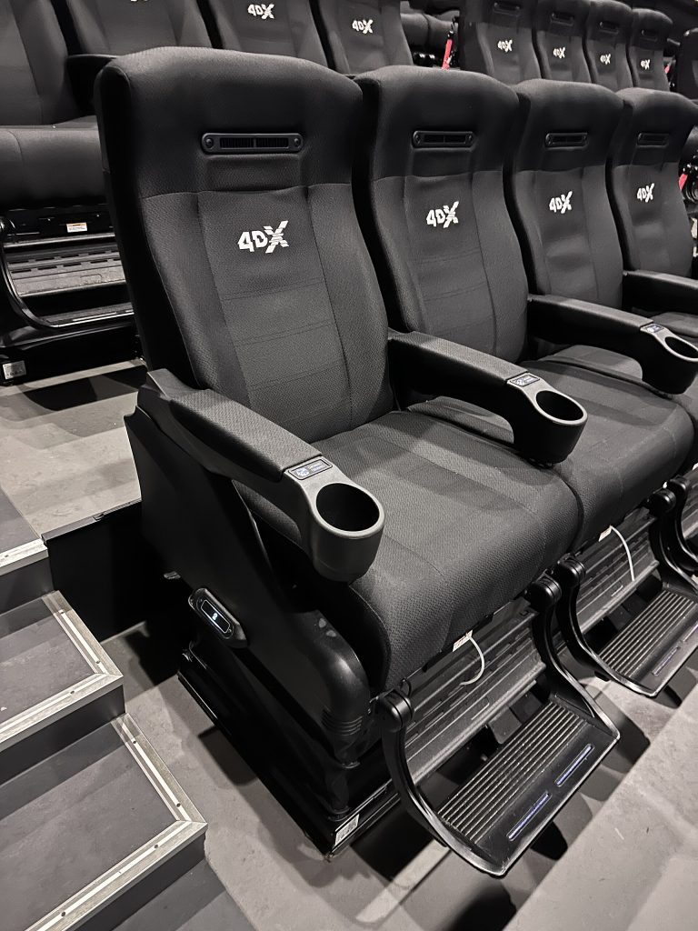 4DX seats in a cinema auditorium (bench rows in a movie theater hall) in Norway. Seating providing motion and environmental effects synced with the on-screen action.