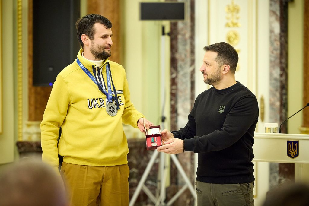 President Volodymyr Zelenskyy met with the athletes of the Ukrainian national Deaflympics team, which won 19 medals at the 20th Winter Deaflympics in the Turkish city of Erzurum. The Head of State awarded the games winners and medalists, thanks to whom Ukraine for the first time took the top spot in the overall team medal tally and won a record number of medals. Volodymyr Zelenskyy noted that he was honored to congratulate Ukrainian athletes today. "You add pride to Ukraine, the opportunity to be proud of people, the strength of Ukrainians, and powerful Ukrainian achievements," he said. The President pointed out that such results contribute to bringing attention back to Ukraine during difficult times of war, especially when it is somewhat out of focus. "And everyone who earns respect for the Ukrainian character and the Ukrainian state helps us all. They help the people to endure. They help our fighters on the front lines in the fight for our independence," said the Head of State. The President congratulated the athletes and their coaches on this extraordinary victory. "Despite all the difficulties, you managed to achieve the top spot for Ukraine. And it's hard to overestimate how important it is today. How important it is for Ukraine to have victories. Because that one victory, for which our boys and girls are sacrificing their lives on the front lines, and the great victory that will surely come, it consists of such important days, such victories as the one you have achieved," he said. According to Volodymyr Zelenskyy, such a historic result at the Deaflympics is another proof of how strong our athletes and Ukrainians are, and how the Ukrainian character prevails over any challenges and circumstances. "I thank all of you for your will to win, for your ability to overcome difficulties, for all the respect that your results have brought to all Ukrainians, to the Ukrainian flag, to the Ukrainian people. I am extremely proud of you. Glory to Ukraine!" concluded the President. Volodymyr Zelenskyy awarded the athletes with Orders of Merit of І-ІІІ class, Orders of Princess Olga of ІІ-ІІІ classes, and the medals "For Labor and Valor." The champion of the 20th Winter Deaflympics, Yelizaveta Nopriienko, thanked the Head of State for supporting the athletes. "Thank you for personally congratulating us. We have all done everything possible and impossible to win. I thank the Armed Forces of Ukraine, and the government for the opportunity to train and show the best results," she said. The athletes presented the President with a hoodie from the uniform of the national Deaflympics team. Volodymyr Zelenskyy also awarded the coaches of the team with the Order of Princess Olga of ІІ class, medals "For Labor and Valor," and bestowed the honorary title of "Honored Worker of Physical Culture and Sports of Ukraine" upon them, recognizing their significant personal contribution to the development of the Deaflympics movement, the training of international-class athletes, and the achievement of high sports results at the 20th Winter Deaflympics. The Order of Merit of І class was also awarded to President of the Ukraine Deaf Sports Federation Leonid Kasitskyi. At the 20th Winter Deaflympics, the Ukrainian team, consisting of 36 athletes, won 10 gold, five silver, and four bronze medals, which is eight more medals than in the previous games. Thus, the Ukrainian team became the world leader in the overall team medal count for the first time in the number of gold medals. In men's and women's events, Ukrainian athletes won 11 medals (six gold, three silver, and two bronze), while in team events, they won eight medals (four gold, two silver, and two bronze). The national Deaflympics team of Ukraine in skiing demonstrated the best result, winning 13 medals (seven gold, four silver, and two bronze) and taking first place in the overall team ranking. In curling, Ukrainian athletes won for the first time among the 11 strongest teams and earned two gold and one bronze medals. In the discipline of mixed doubles curling, athletes Mykhailo Pleskanka and Kateryna Yakymets defeated the team from the Republic of Korea in the final match and won the gold medal. The chess team won one gold, one silver, and one bronze medal and took second place in the overall team medal count among 16 participating countries. The women's team won gold in the classical chess games, while mixed teams won silver and bronze medals.
