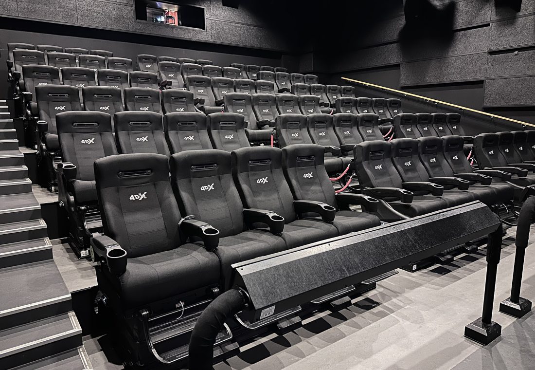 4DX seats in a cinema auditorium (bench rows in a movie theater hall) in Norway. Seating providing motion and environmental effects synced with the on-screen action.