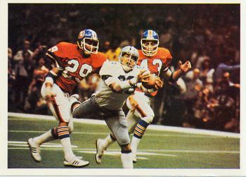 A football card from the 1986 Jeno's Pizza NFL football card stickers set of Dallas Cowboys wide receiver Butch Johnson catching a touchdown pass against the Denver Broncos in Super Bowl XII. The card is numbered #2 in the set. The back of the card reads: A SUPER CATCH BY BUTCH JOHNSON Dallas wide receiver Butch Johnson makes a spectacular, diving catch of a 45-yard touchdown pass from Roger Staubach, as the Cowboys defeat Denver 27-10 in Super Bowl XII. Johnson beat Denver defensive backs Bernard Jackson (29) and Steve Foley. The Dallas defense helped set up the victory by intercepting four passes and recovering four fumbles.